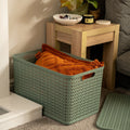 Plastic Box Shop extra large sage green storage basket with lid, textured weave design, holding orange blankets.